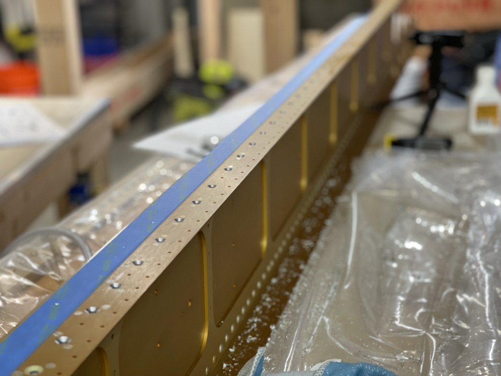Wing spar with countersunk holes.