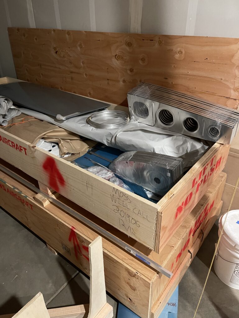 Aircraft parts in wooden crate.