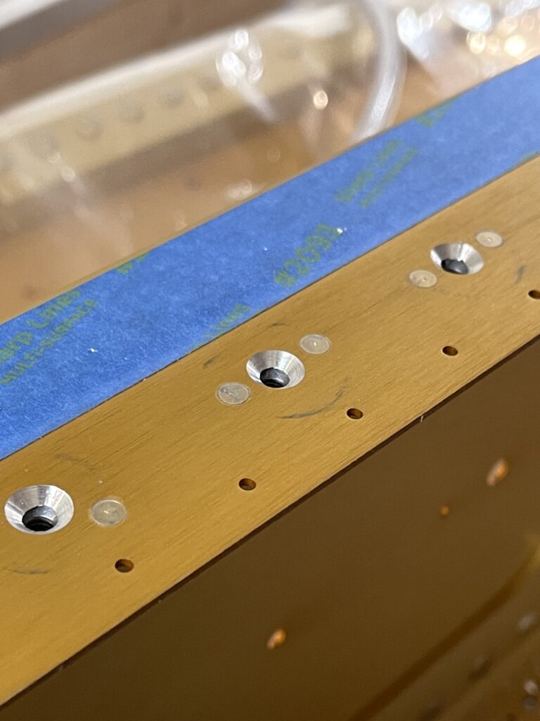 Machined holes in aluminum hardware.