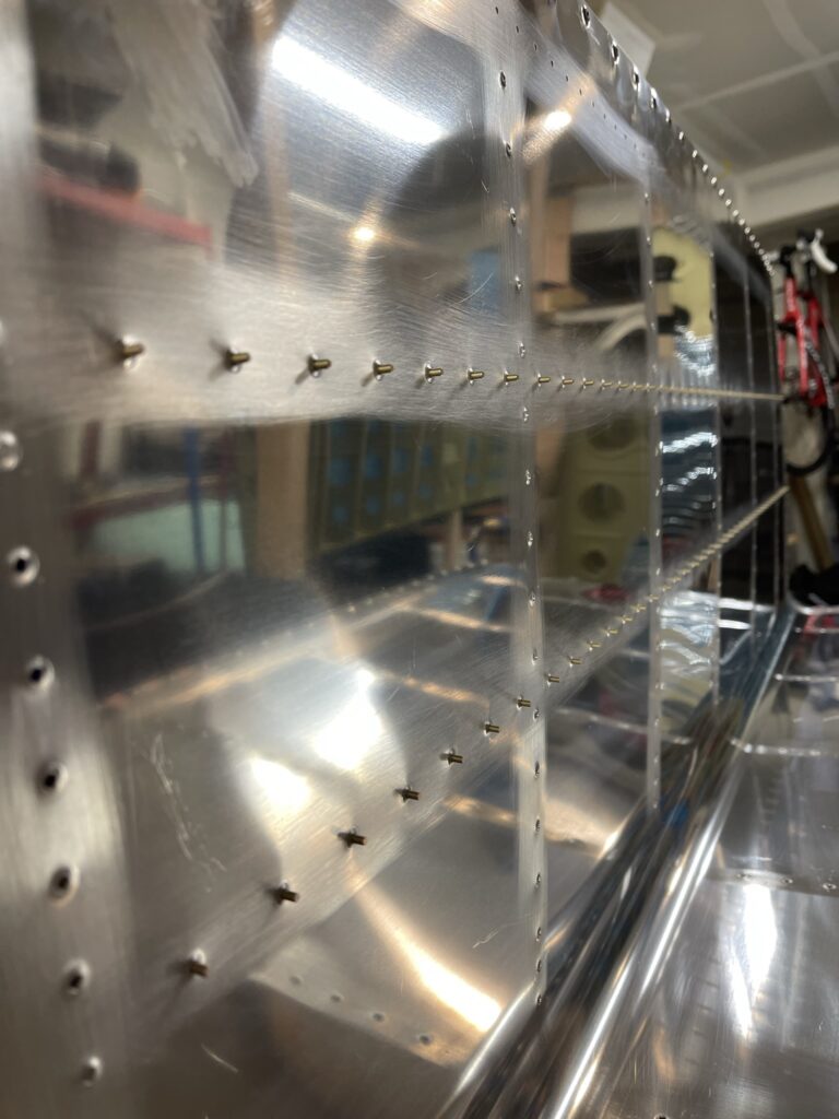 Rivets protruding from an aluminum skin